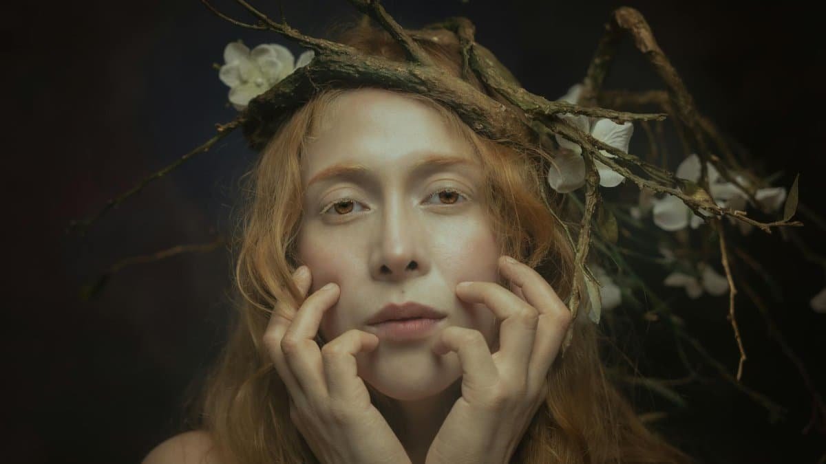 A captivating portrait of a woman with a crown of branches and flowers, blending medieval and natural aesthetics.