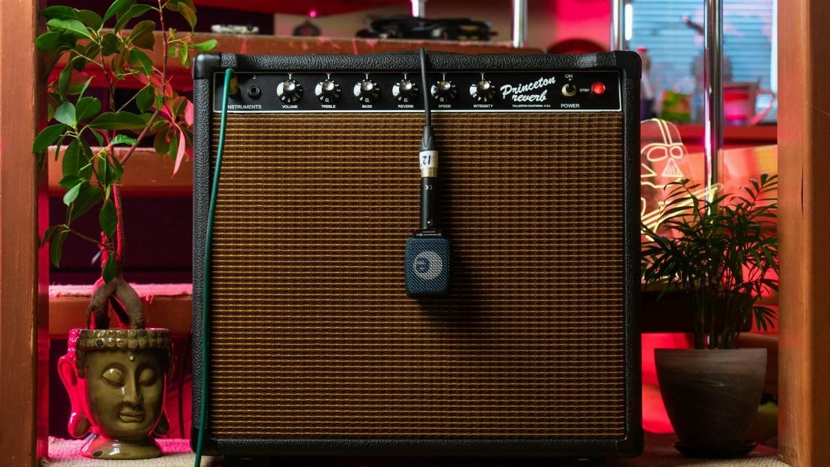 A retro combo amplifier with a microphone in a cozy indoor setting.
