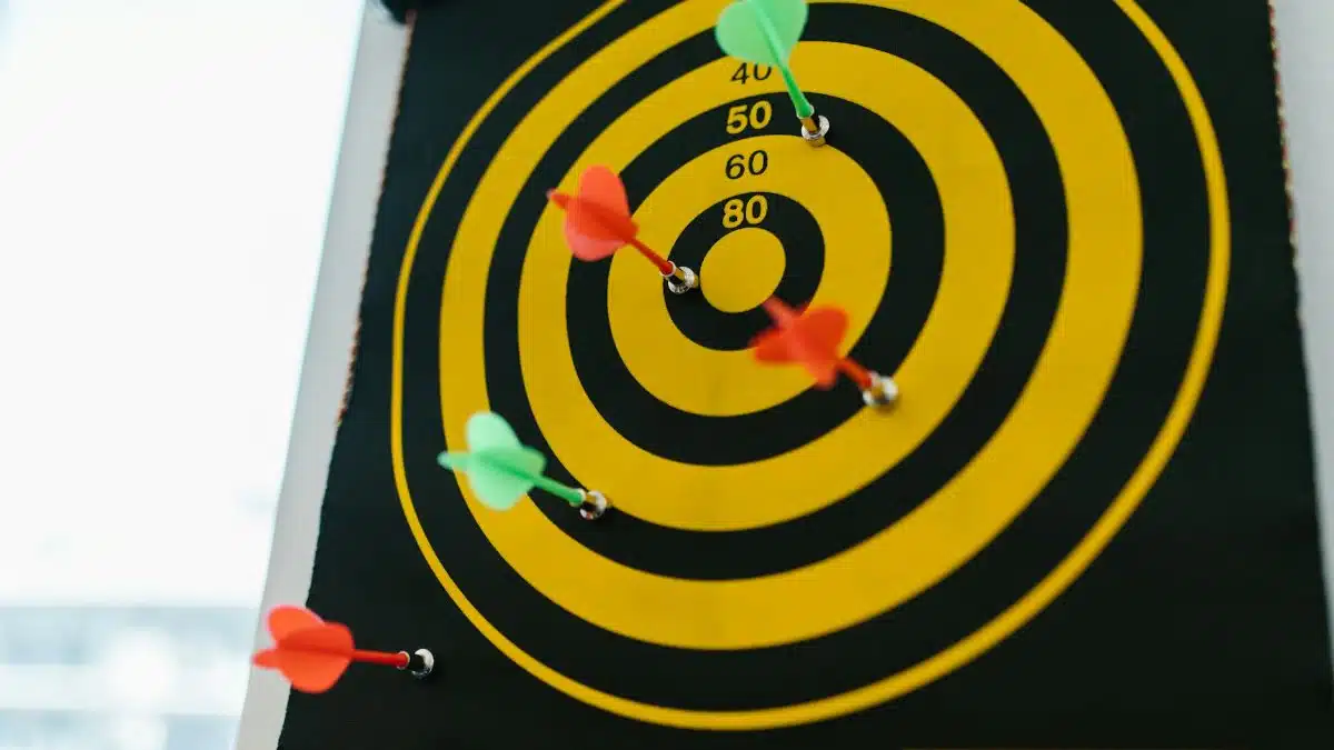 Vibrant darts stuck in a yellow and black dartboard representing precision and strategy.