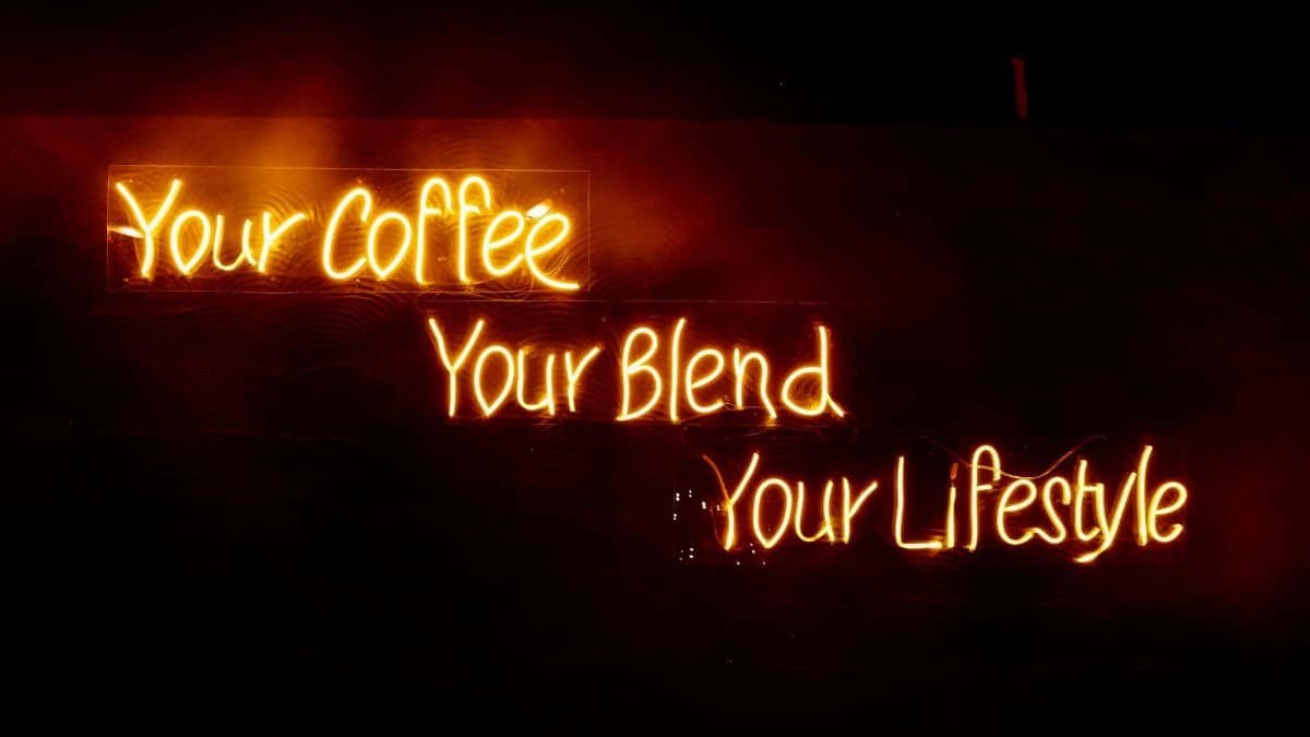 Glowing neon sign saying 'Your Coffee, Your Blend, Your Lifestyle' in warm tones, perfect for cafes.