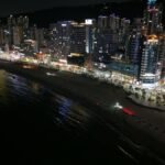 Stunning night view of Busan's illuminated cityscape along the coastline.