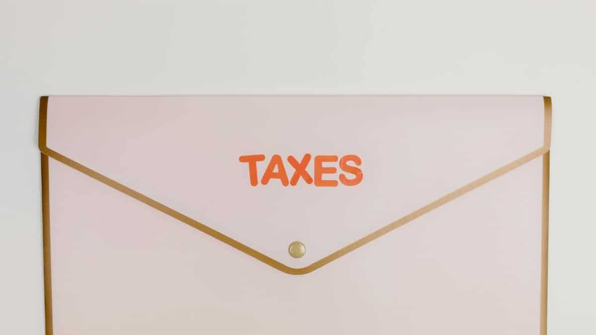 Minimalist pastel pink envelope labeled 'TAXES' perfect for finance or tax-themed visuals.