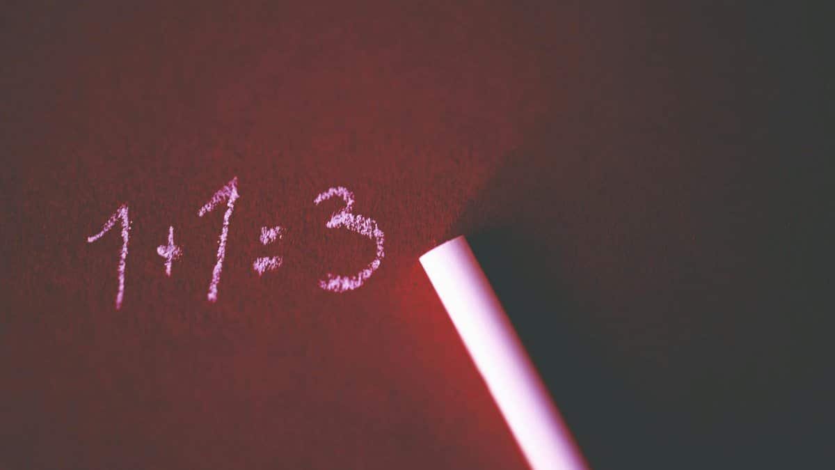Close-up of a chalkboard with a humorous math error showing 1+1=3 written in chalk.