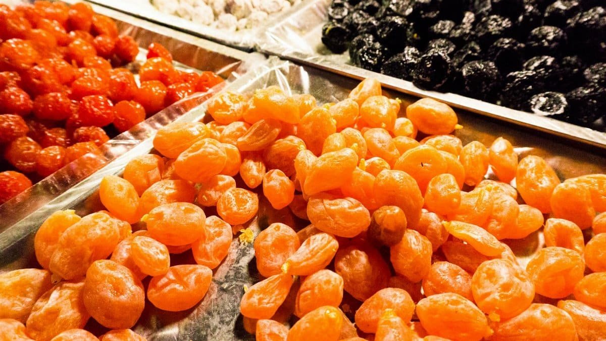 Vibrant selection of dried fruits including apricots and cherries, displayed at a market stall.