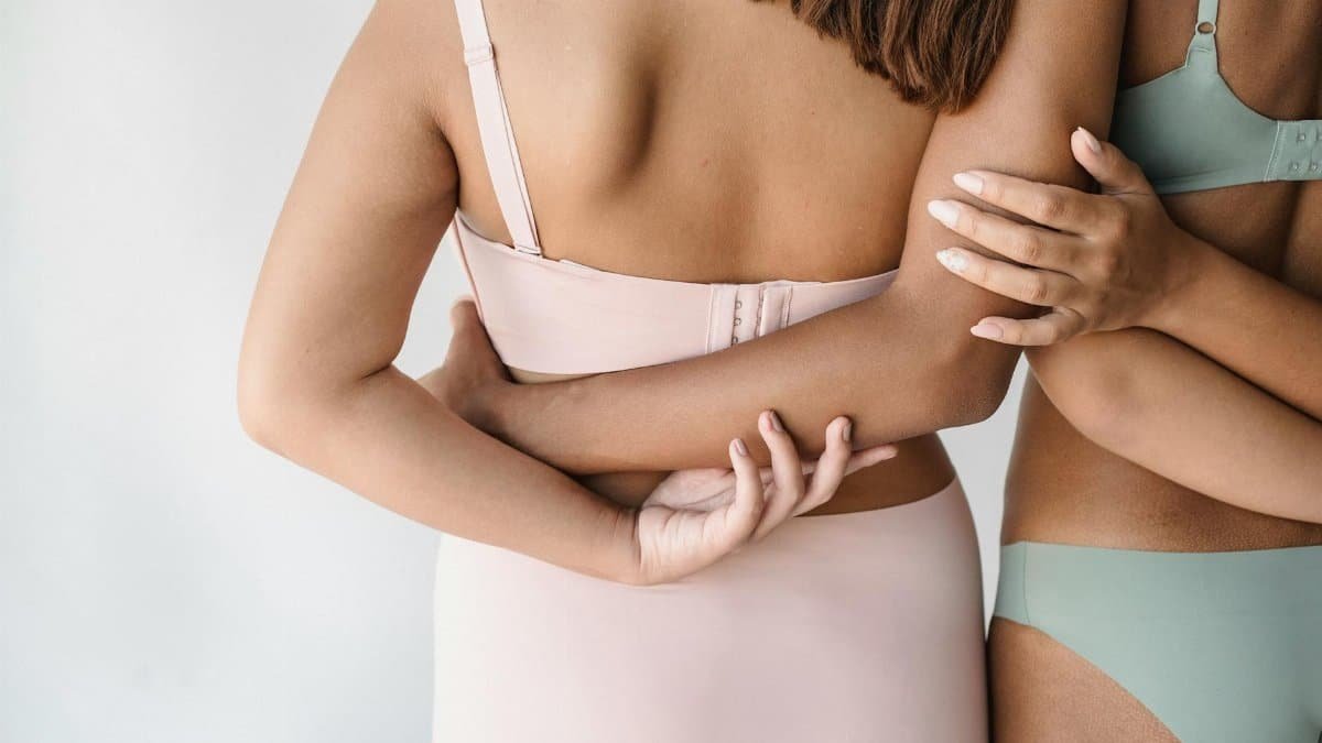 A close-up of diverse women embracing body positivity and support in modern lingerie.