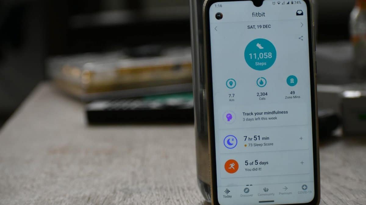 Close-up of a smartphone displaying a fitness tracking app with health statistics.