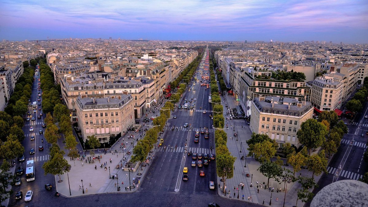 Stunning aerial photo of Paris showcasing the historic Champs-Élysées at dusk.