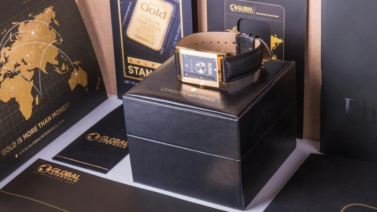 Opulent gold watch displayed with global branding materials, exuding luxury and wealth.