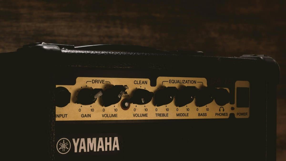 Detailed view of a Yamaha amplifier showing control knobs and settings.