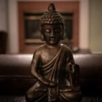 Close-up of a Buddha statue emphasizing tranquility and mindfulness within an indoor setting.