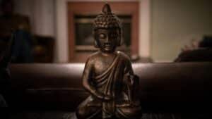 Close-up of a Buddha statue emphasizing tranquility and mindfulness within an indoor setting.