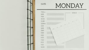 Top view of a minimalist schedule planner with Monday header. Perfect for organizing daily tasks with goals section.