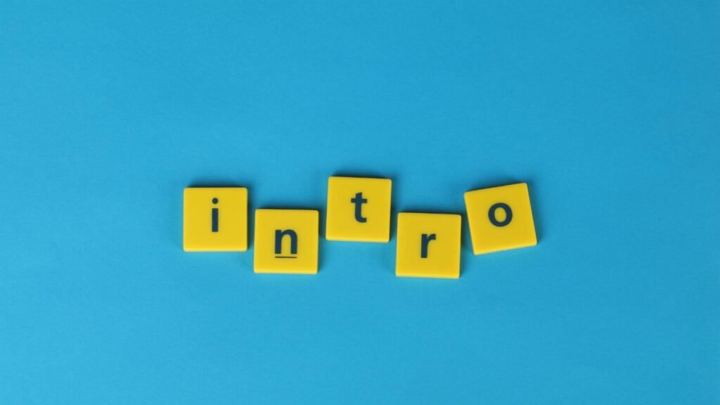 Yellow letter tiles spell 'intro' on a vibrant blue background, ideal for creative projects.