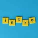 Yellow letter tiles spell 'intro' on a vibrant blue background, ideal for creative projects.