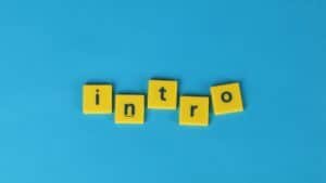 Yellow letter tiles spell 'intro' on a vibrant blue background, ideal for creative projects.