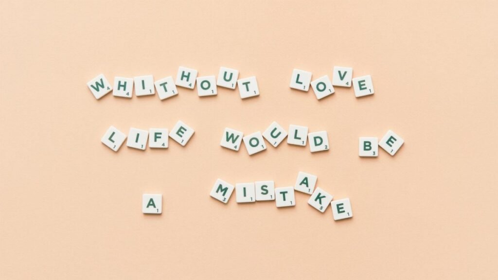 Scrabble tiles forming the phrase 'Without love life would be a mistake' on a beige background.