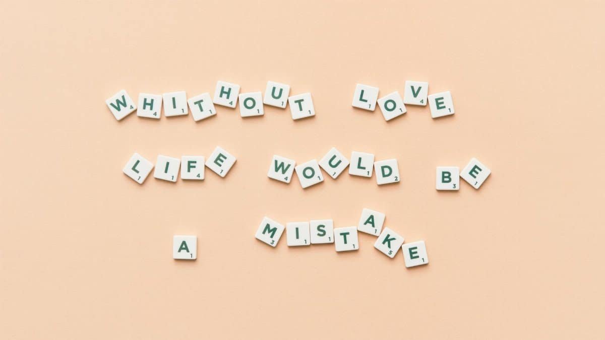 Scrabble tiles forming the phrase 'Without love life would be a mistake' on a beige background.