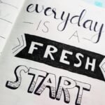 Notebook page featuring motivational quote 'Everyday is a fresh start' with colorful pens.