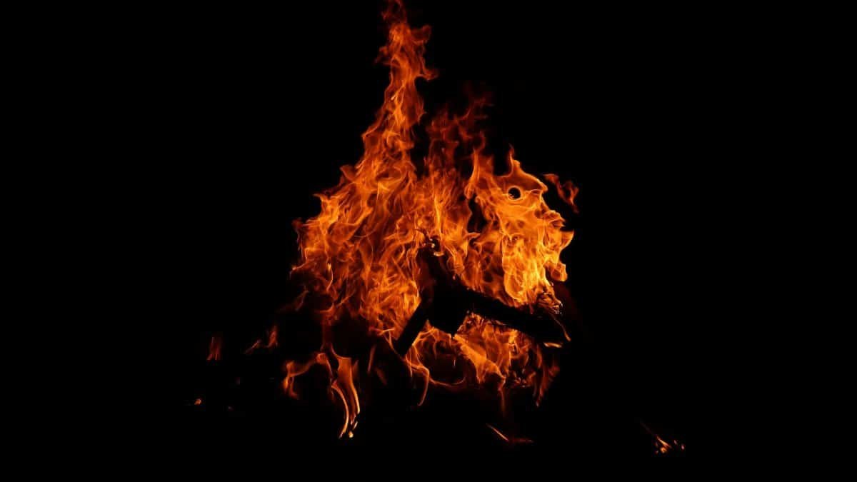 Captivating image of a bonfire with bright flames illuminating the dark night.