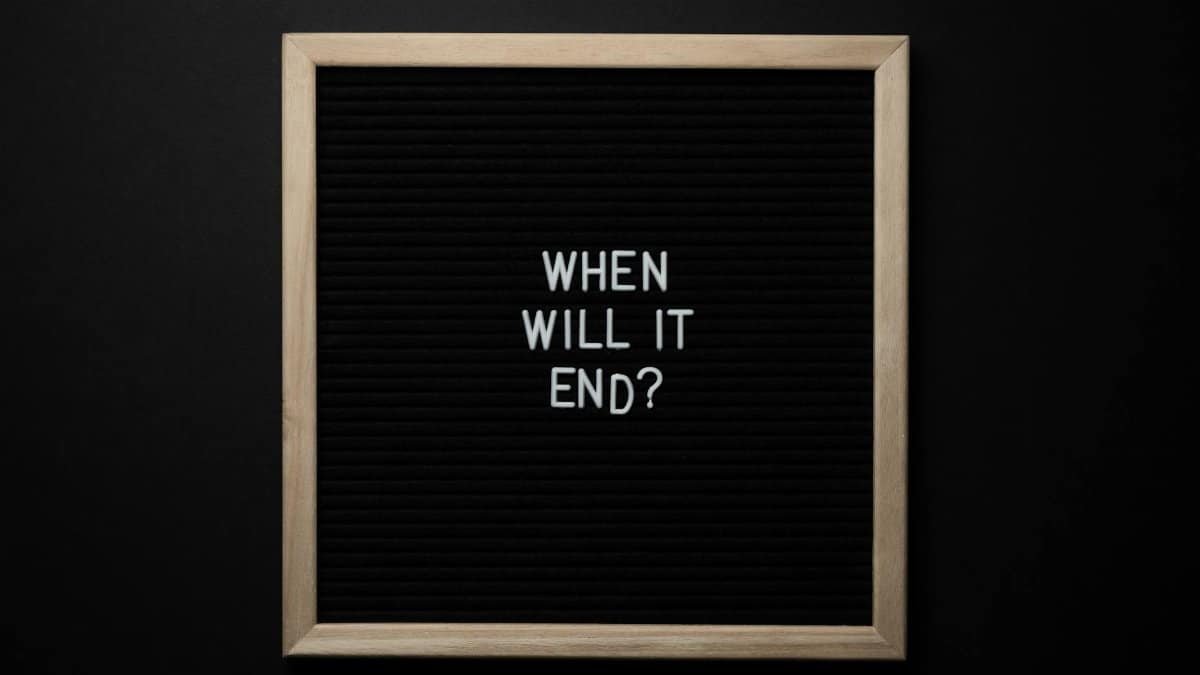 A minimalist black board with the text 'When Will It End?' on a dark background.