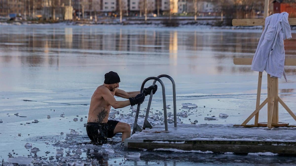 Shirtless man in freezing lake near Ludvika, Sweden, captured during a winter swim. Sublime ice scenery.