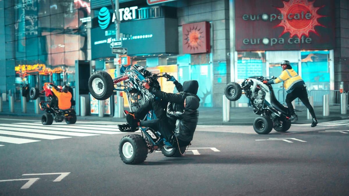 ATV stunt riders perform jaw-dropping tricks on New York City streets at night.