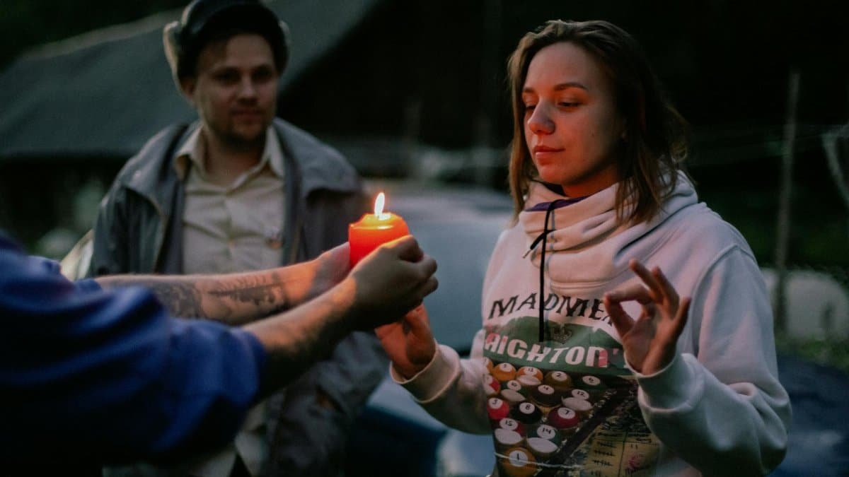 A serene moment of spirituality and reflection by candlelight outdoors.