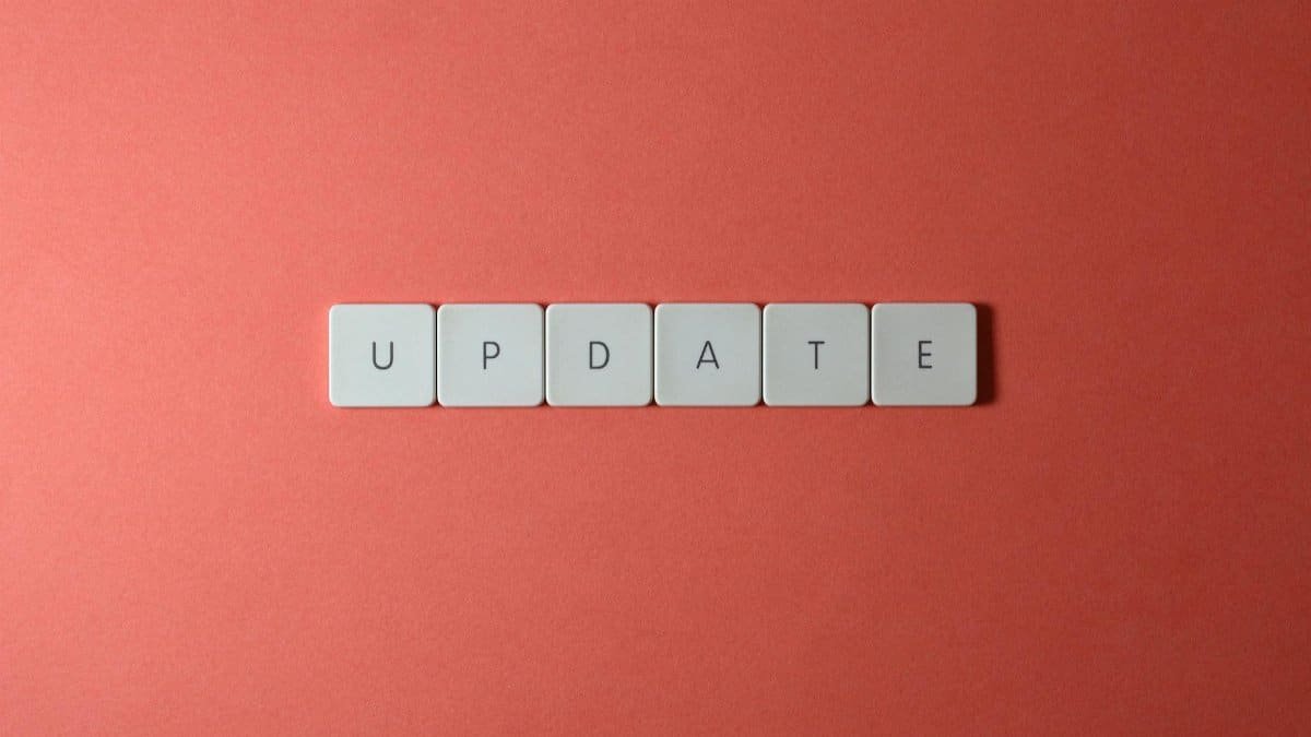 Keyboard keys arranged to spell 'update' on a vibrant red background, ideal for conveying tech concepts.