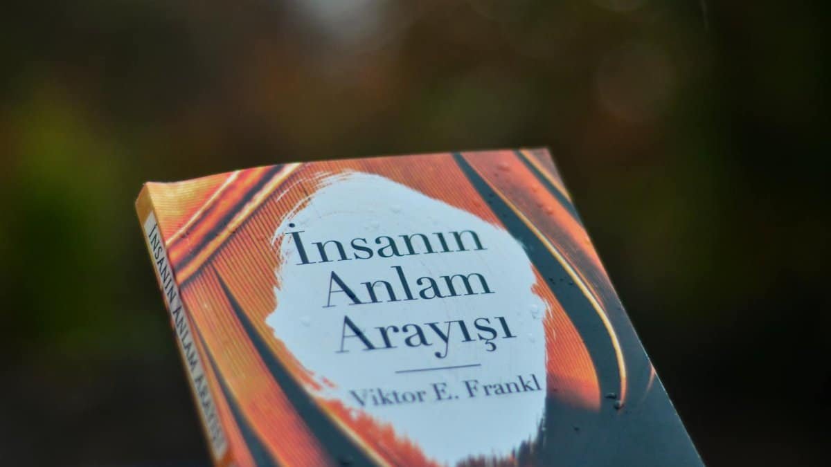 Close-up of 'Man's Search for Meaning' book cover by Viktor E. Frankl outdoors.