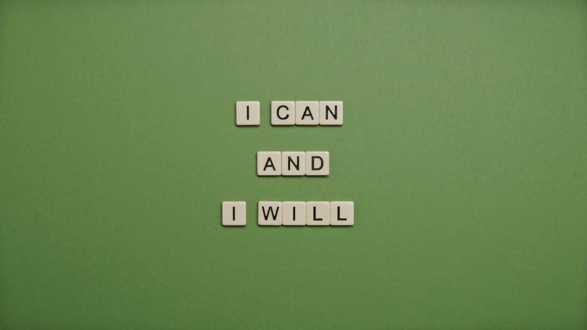 Inspirational message 'I Can and I Will' spelled with tile letters on a green background.