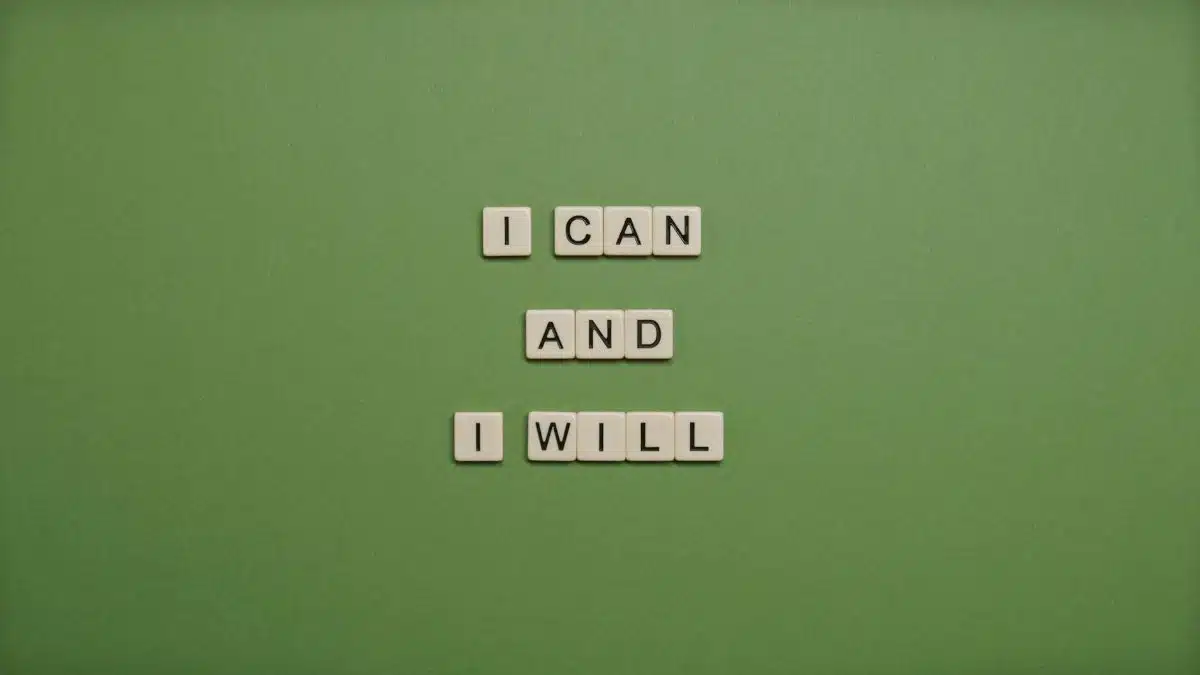 Inspirational message 'I Can and I Will' spelled with tile letters on a green background.