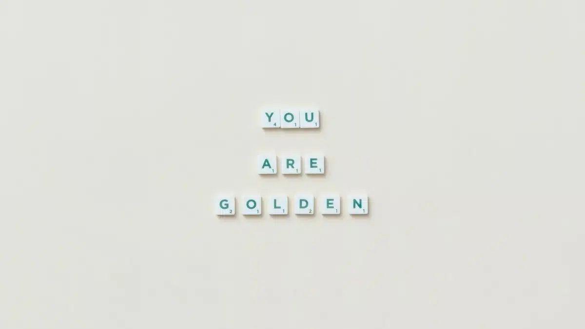 Scrabble tiles spelling 'You Are Golden' on a light background.