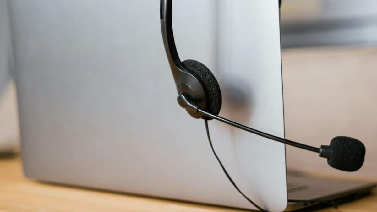 A laptop with a headset attached, ideal for virtual meetings or online customer support.