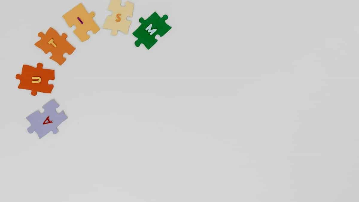 Puzzle pieces spelling autism on a white background, symbolizing autism awareness.
