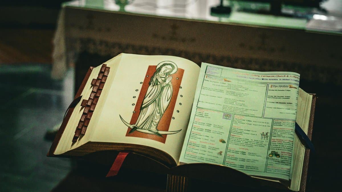An open prayer book with religious imagery inside a church in Ireland, capturing spiritual essence.