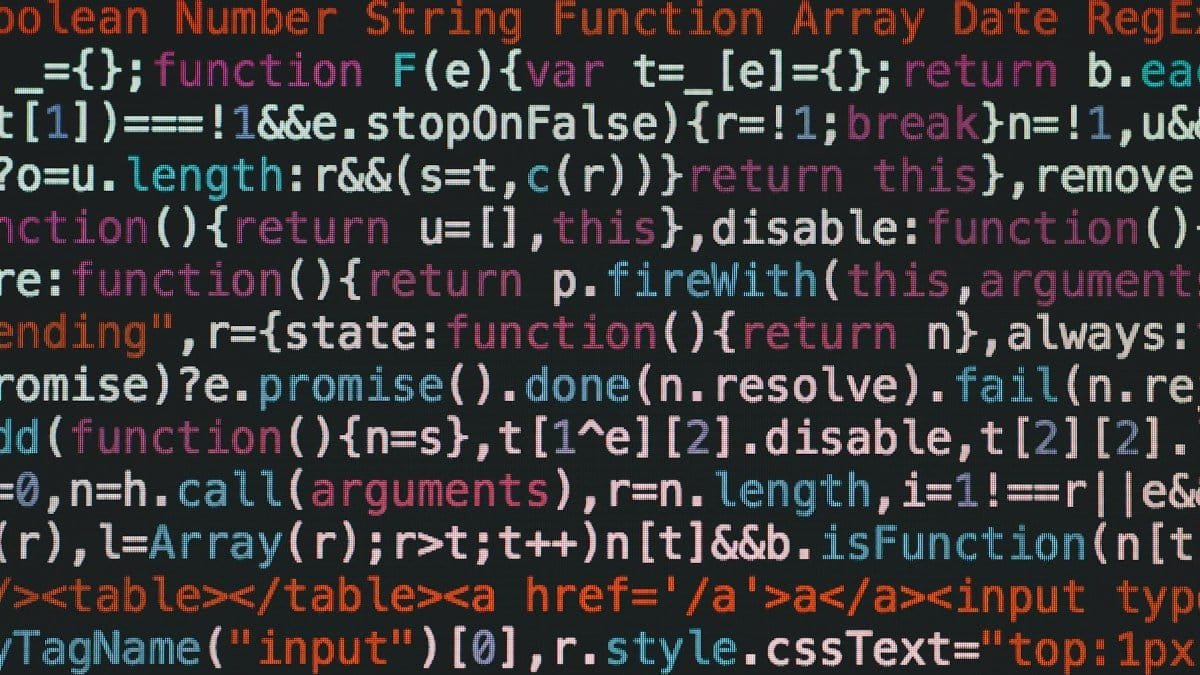 Close-up of colorful coding text on a dark computer screen, representing software development.