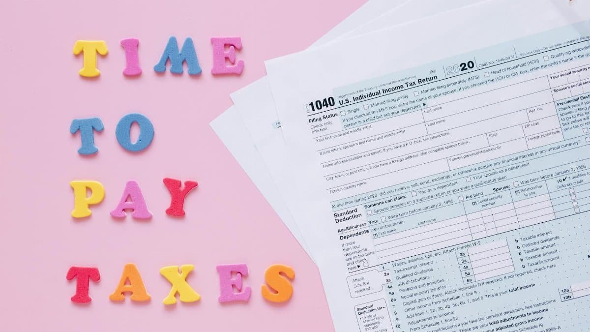 1040 tax forms with colorful 'Time to Pay Taxes' letters.