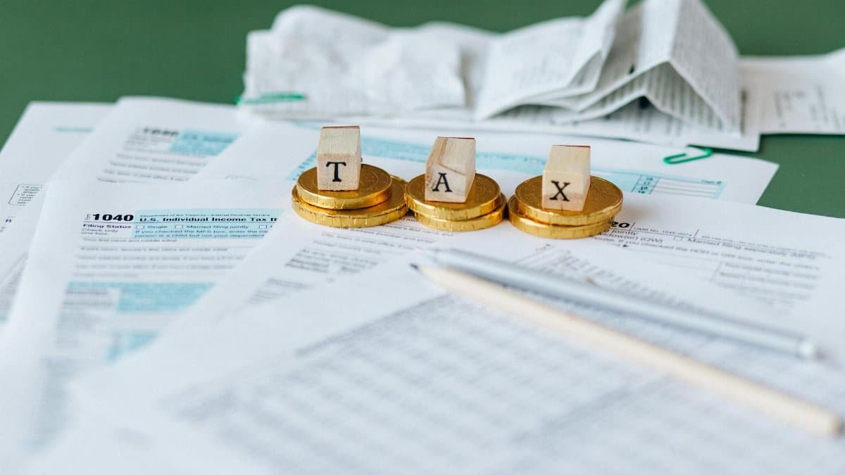 Close-up of tax forms, receipts, and coins symbolizing financial accounting and taxes.