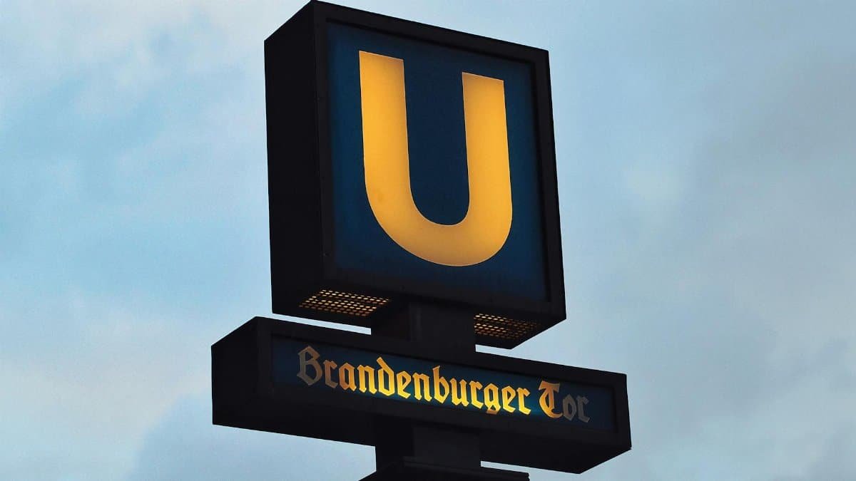 U-Bahn sign at Brandenburger Tor station in Berlin, Germany against a cloudy sky.