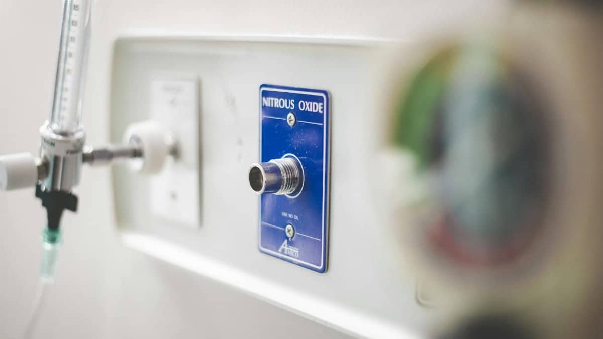 Close-up of nitrous oxide outlet and equipment in a hospital setting.