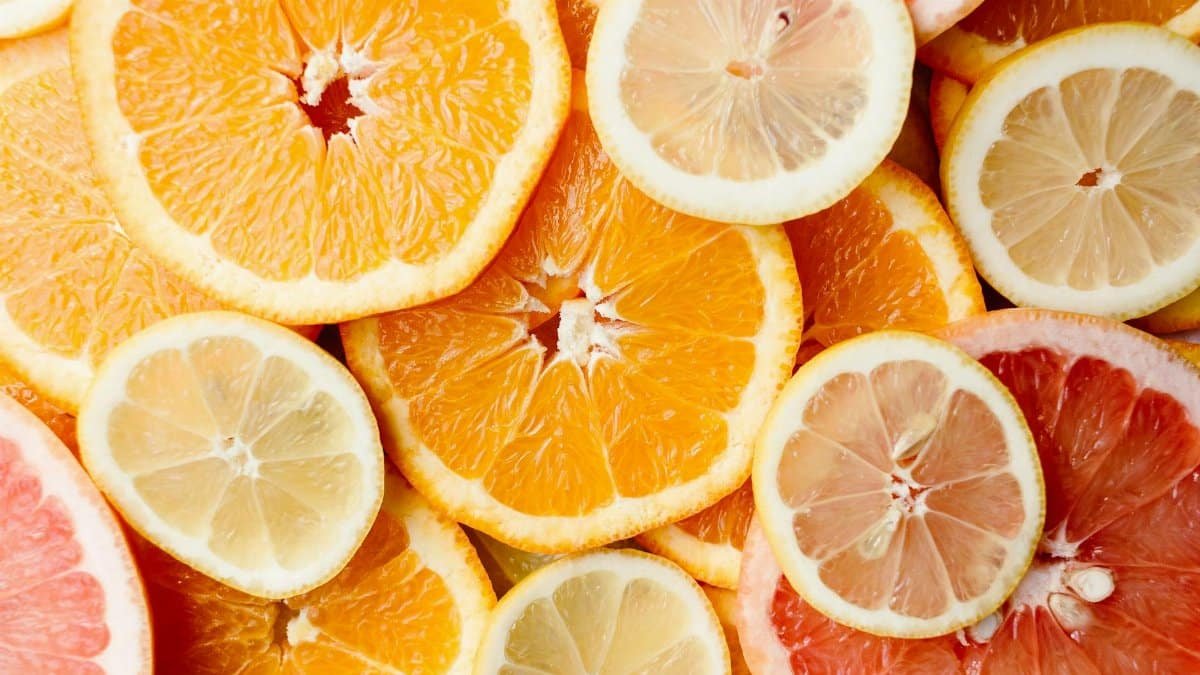 Close-up of fresh, sliced citrus fruits showcasing oranges, lemons, and grapefruits.