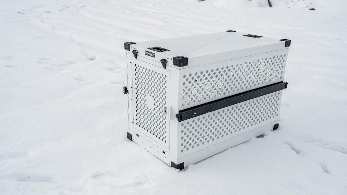 Sturdy pet crate designed for cold conditions, shown in a snowy outdoor setting.