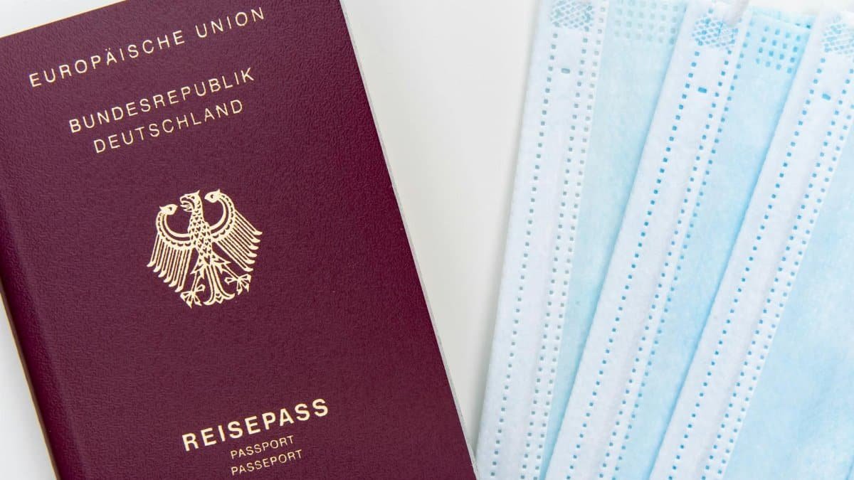 German passport and face masks concept for travel safety during pandemics.