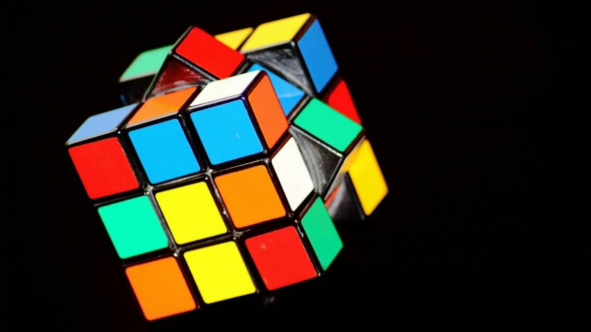A close-up of a colorful Rubik's Cube puzzle, showcasing concentration and play.
