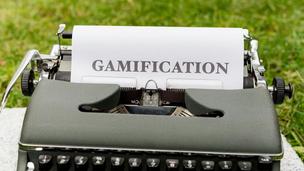 Close-up of a vintage typewriter displaying the word 'GAMIFICATION' on paper outdoors.
