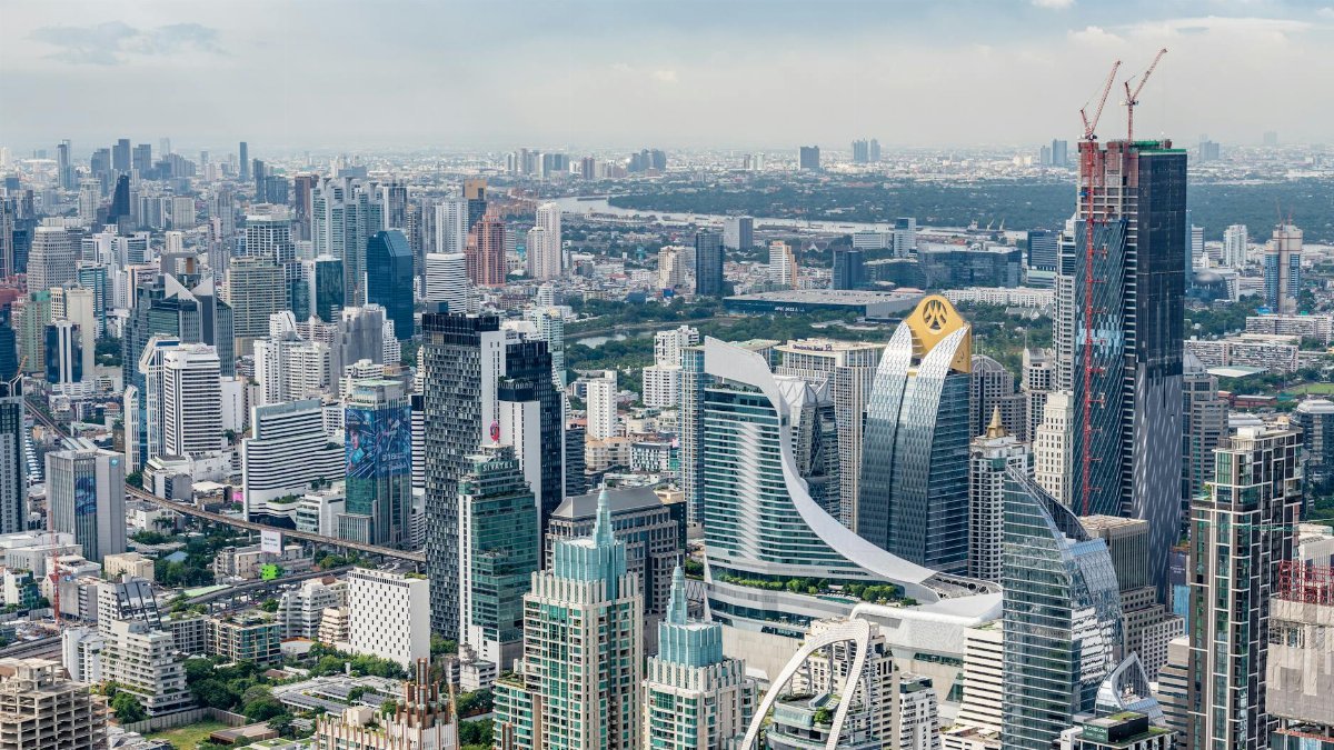 Aerial view of a bustling cityscape showcasing modern skyscrapers and vibrant urban development.
