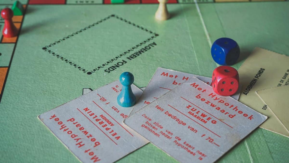 Close-up of vintage Monopoly game pieces and cards on a game board.