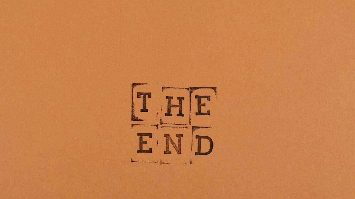 Stamped text 'The End' on an orange background offering creative copyspace.