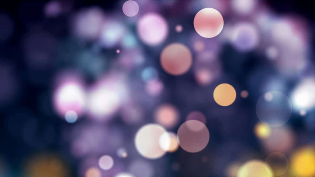 Vibrant abstract bokeh background with colorful lights and sparkles.