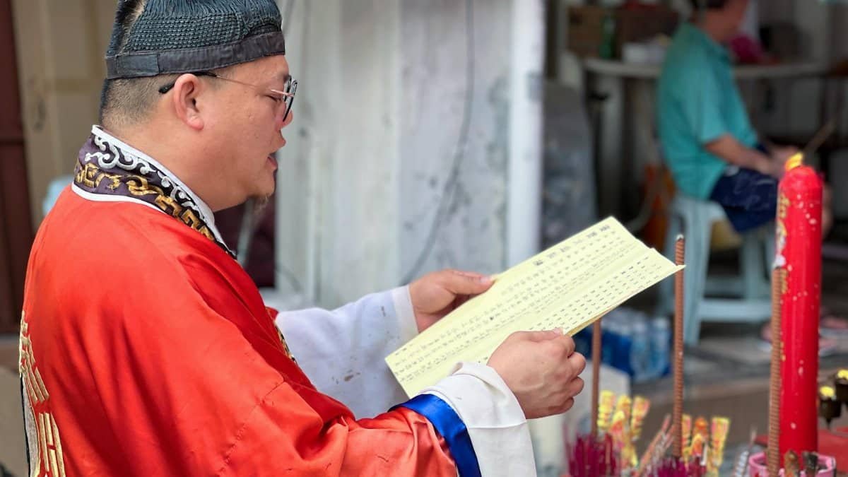 A Taoist priest conducts a traditional ceremony with incense in George Town, Penang.